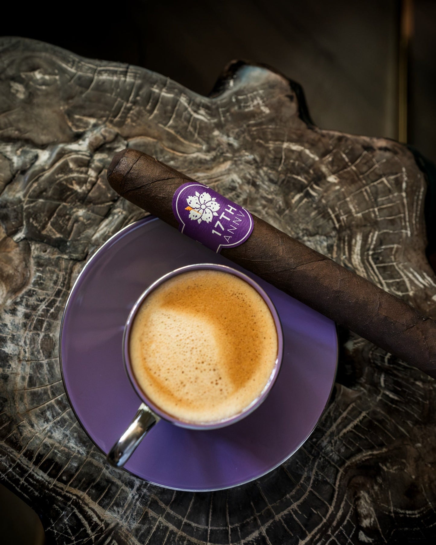 Room 101 17th Anniversary 6x52 Nicaraguan toro cigar beside espresso on a purple saucer